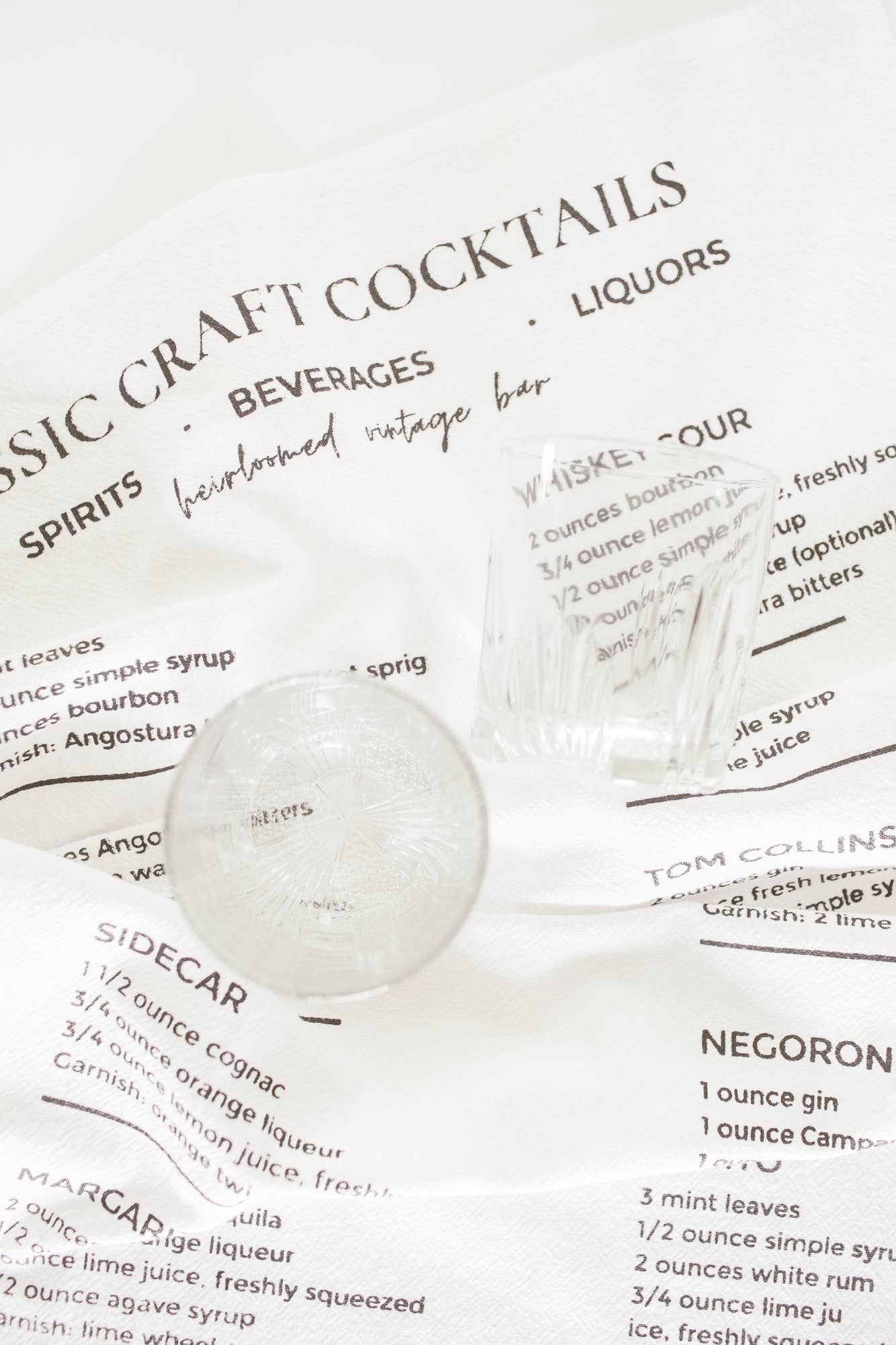 Close-up of cocktail recipe print on cotton tea towel