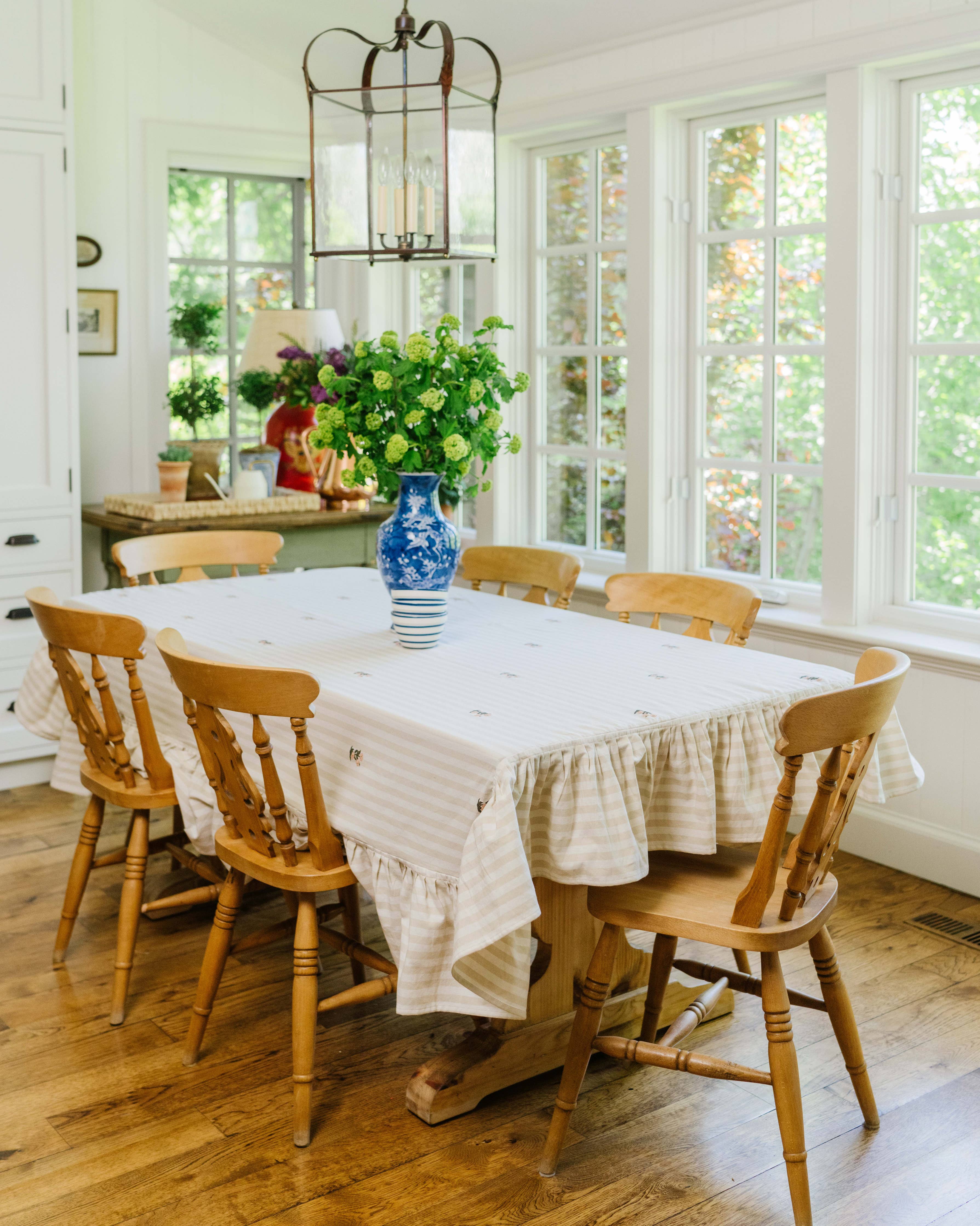 Cotton tablecloth with cream stripes, ruffle edge, and embroidered floral details