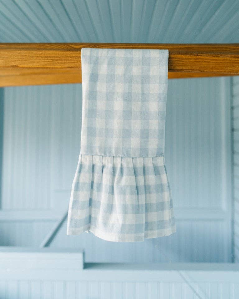 Cozy kitchen with gingham dish towel draped over oven handle