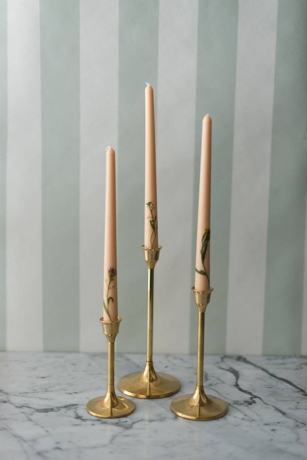 Vintage-inspired floral candles styled in brass candleholders