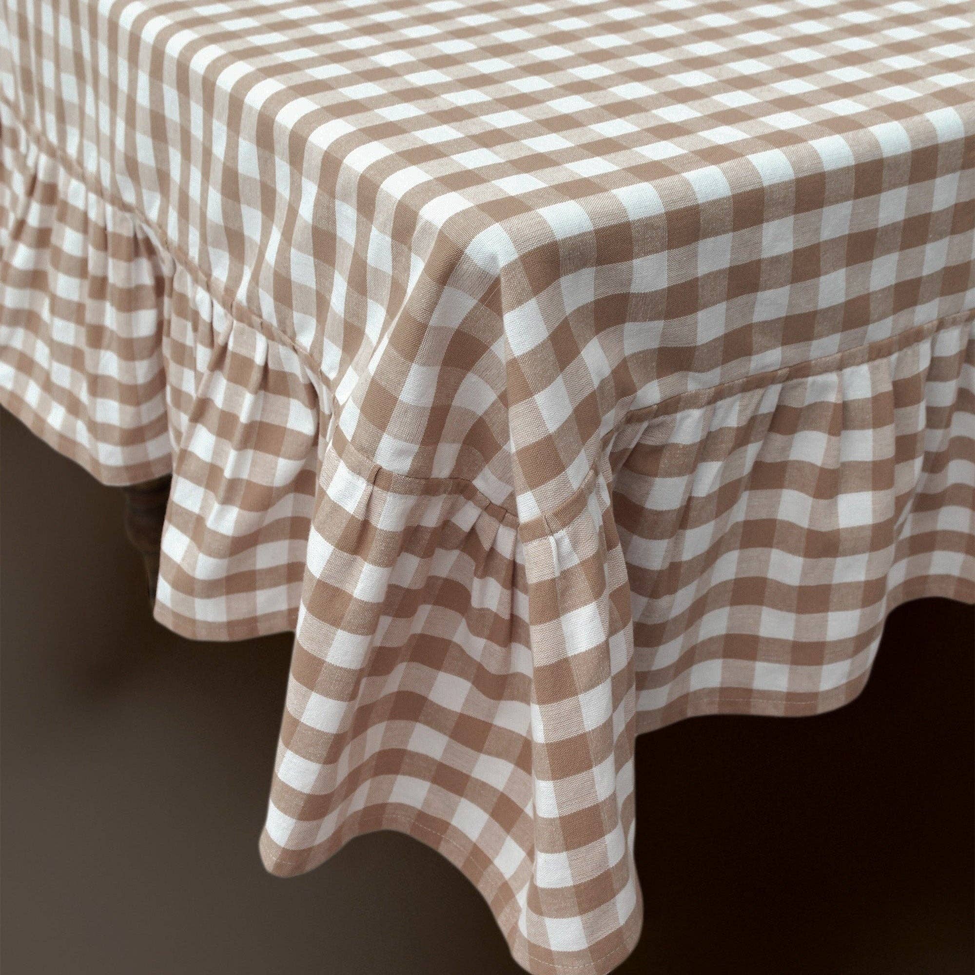 Farmhouse-style gingham tablecloth with soft ruffled border