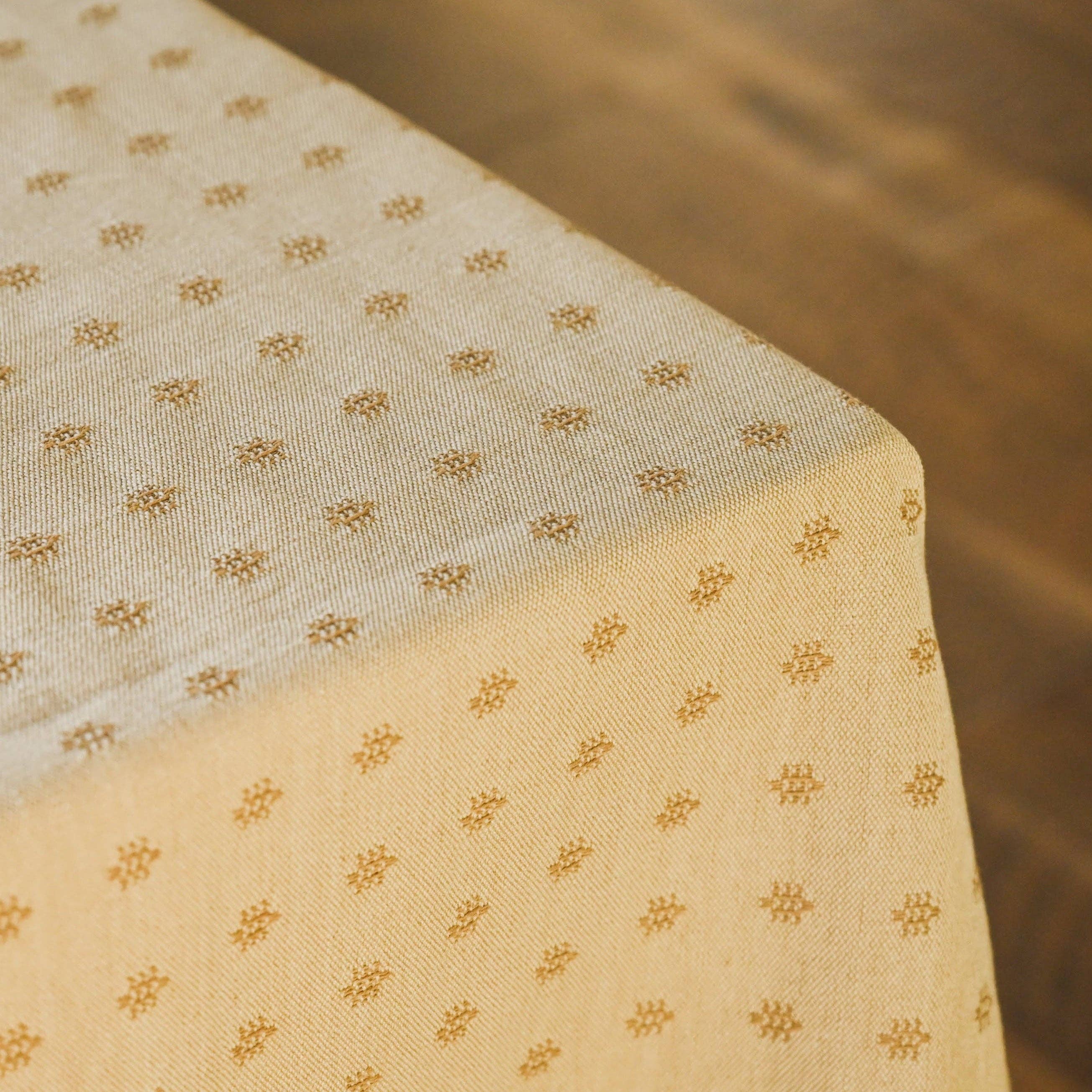 Textured linen tablecloth in warm umber tone for dining table