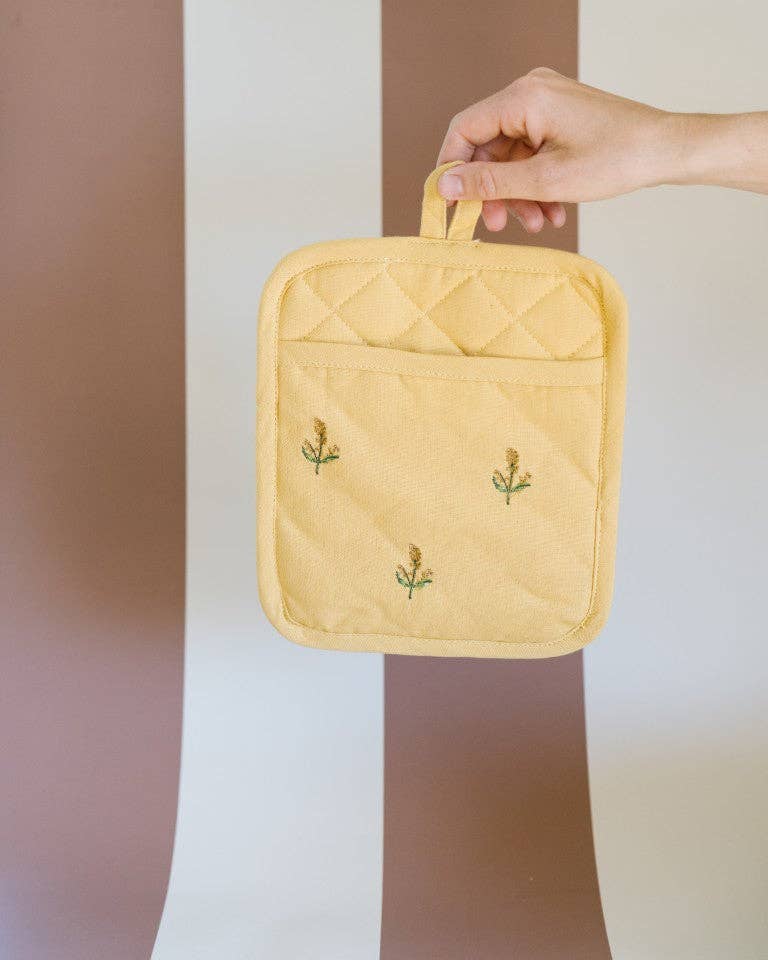 Close-up of floral embroidery on cotton pot holder